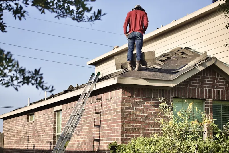 Professional roofer working on a residential roof in Everett Mall South